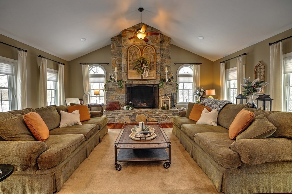 59 Lake Road Brookfield, MA 01506 - Photo 3 of 42 a living room with furniture a fireplace and a chandelier