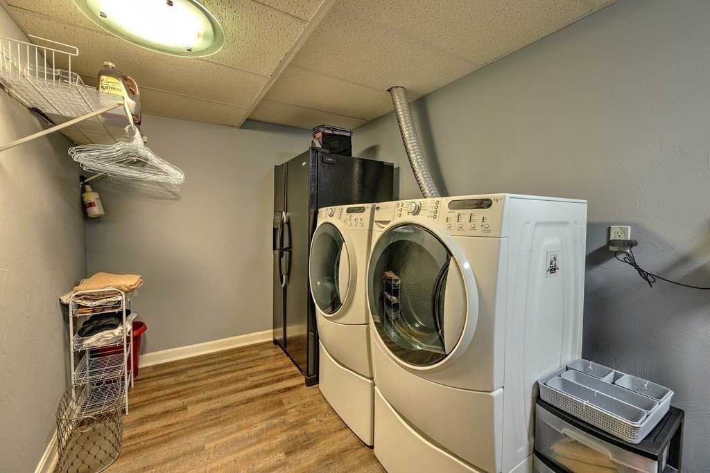 59 Lake Road Brookfield, MA 01506 - Photo 31 of 42 a utility room with dryer washer and a wooden floor