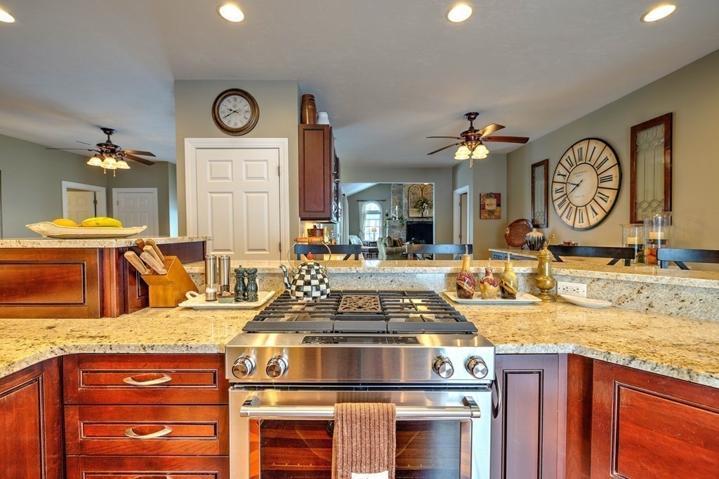59 Lake Road Brookfield, MA 01506 - Photo 8 of 42 a kitchen with a stove and a clock on the wall