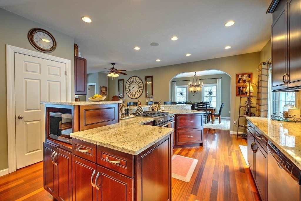 59 Lake Road Brookfield, MA 01506 - Photo 9 of 42 a view of a kitchen with kitchen island granite countertop wooden floor and stainless steel appliances