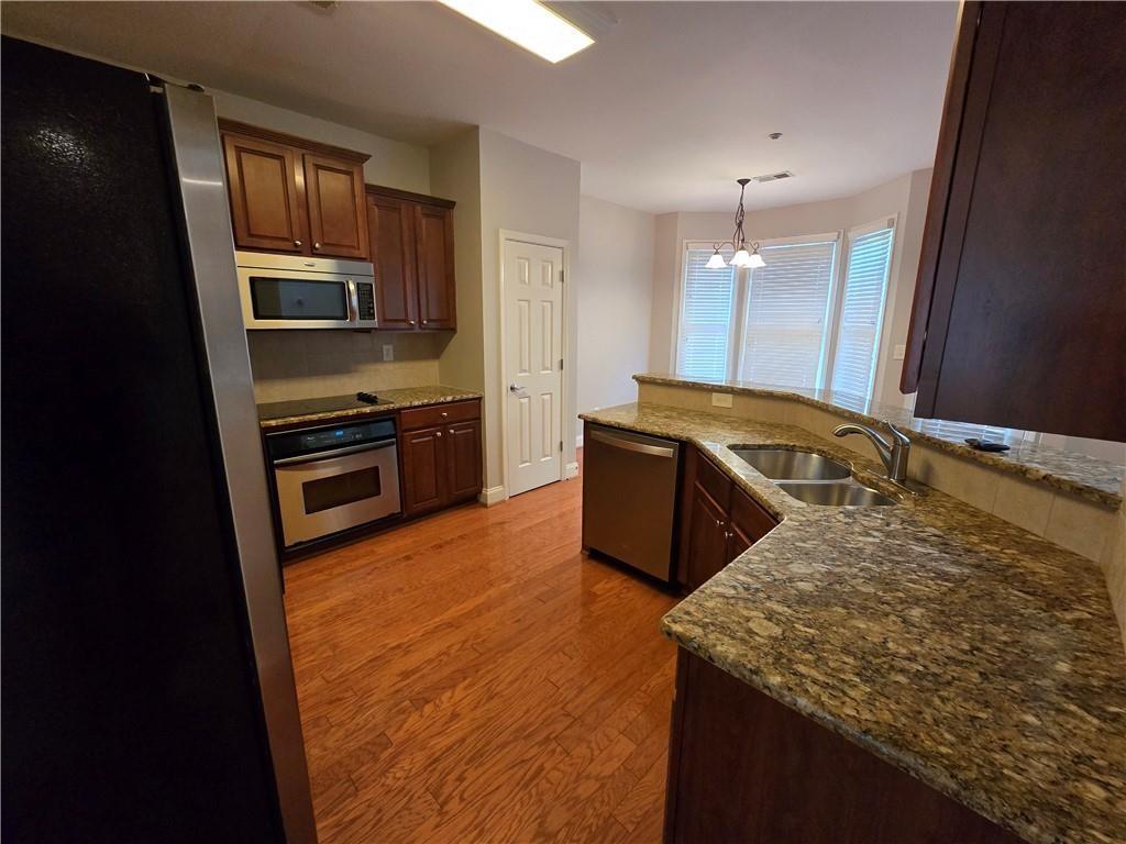 624 Maple Grove Way Marietta, GA 30066 - Photo 9 of 27 a kitchen with stainless steel appliances granite countertop a sink stove and refrigerator