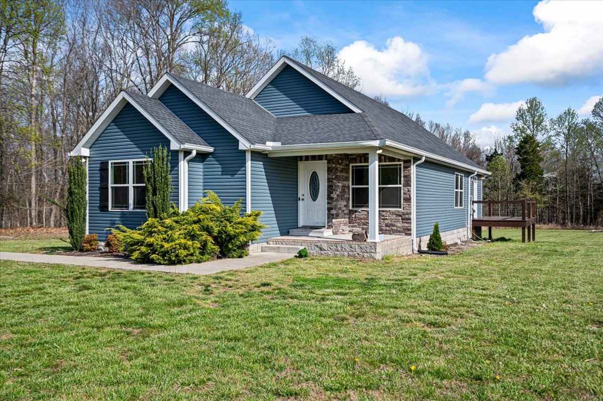 a front view of a house with a garden and porch