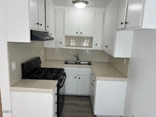 a kitchen with cabinets appliances and a sink