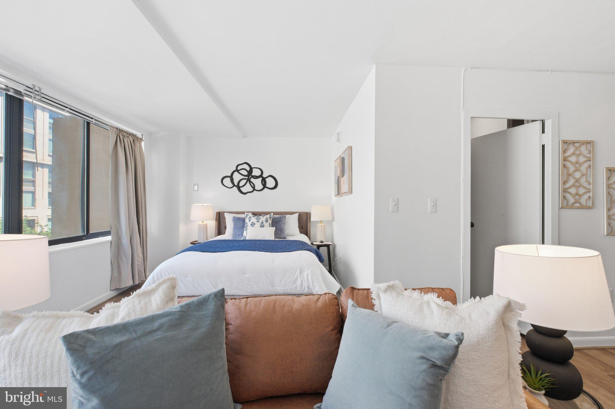 522 21st Street Northwest, Unit 407 Washington, DC 20006 - Photo 13 of 17 a bedroom with a bed and a window