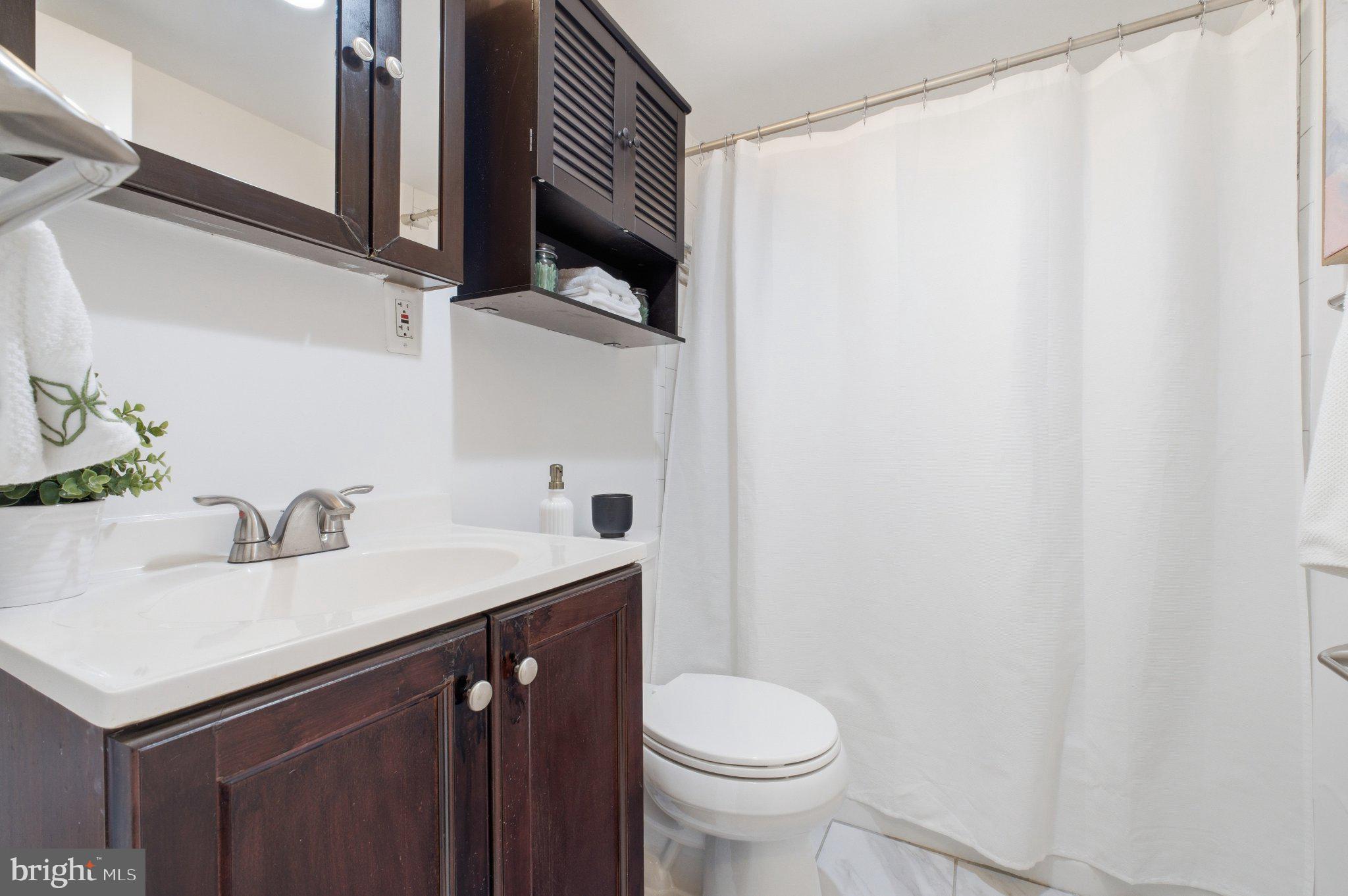 522 21st Street Northwest, Unit 407 Washington, DC 20006 - Photo 14 of 17 a bathroom with a sink and a mirror