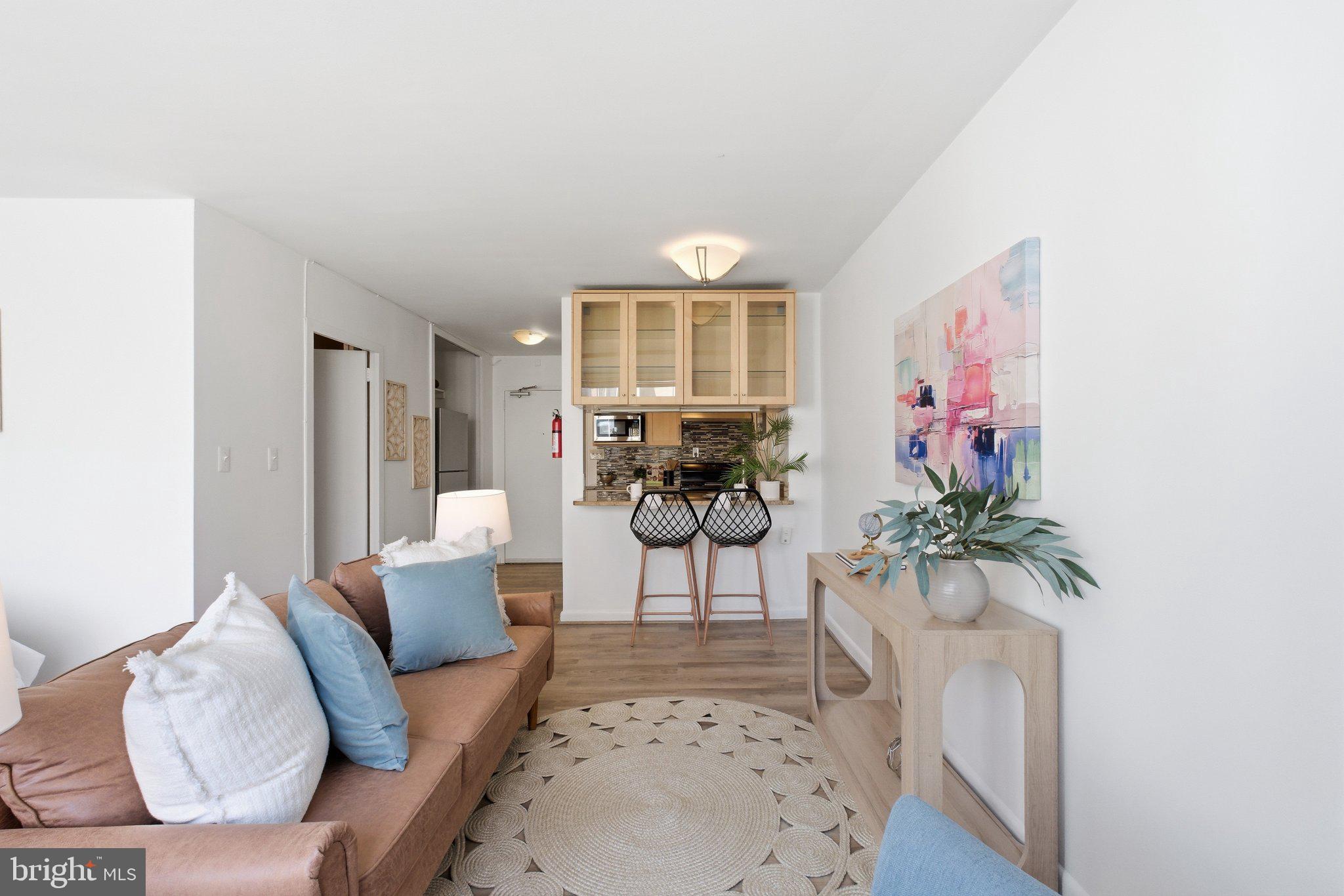 522 21st Street Northwest, Unit 407 Washington, DC 20006 - Photo 3 of 17 a living room with furniture and a potted plant