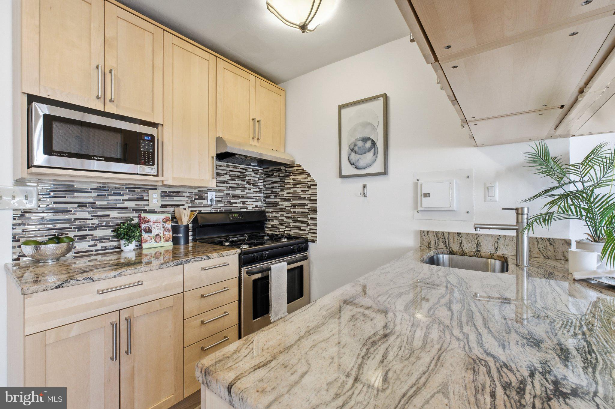 522 21st Street Northwest, Unit 407 Washington, DC 20006 - Photo 5 of 17 a kitchen with stainless steel appliances granite countertop a stove and cabinets