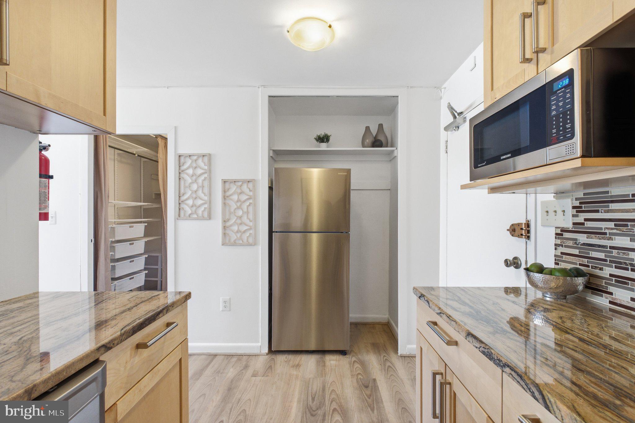 522 21st Street Northwest, Unit 407 Washington, DC 20006 - Photo 7 of 17 a kitchen with stainless steel appliances granite countertop a refrigerator stove and microwave