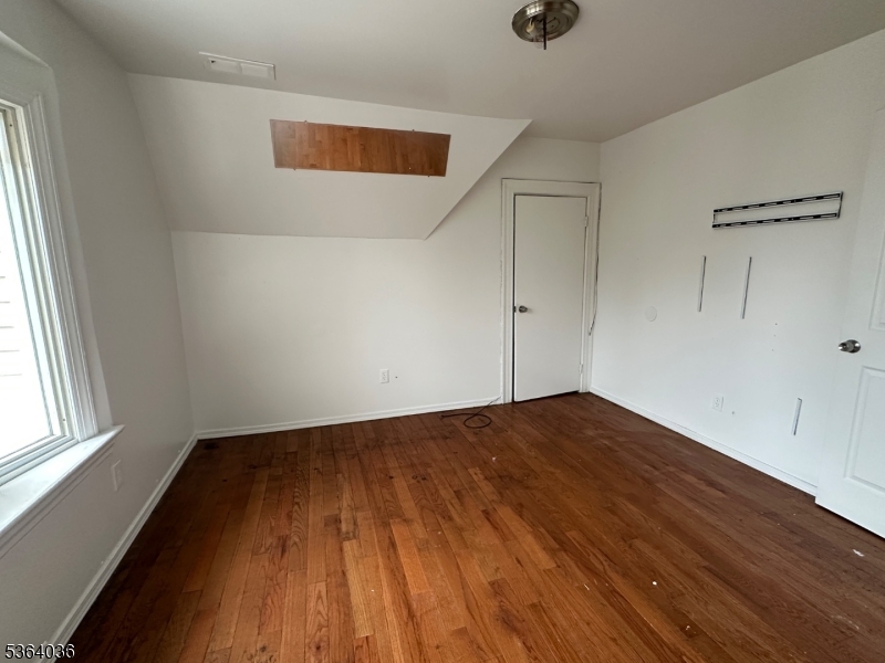 348 13th Avenue, Unit 3 Newark, NJ 07103 - Photo 12 of 14 an empty room with wooden floor and windows