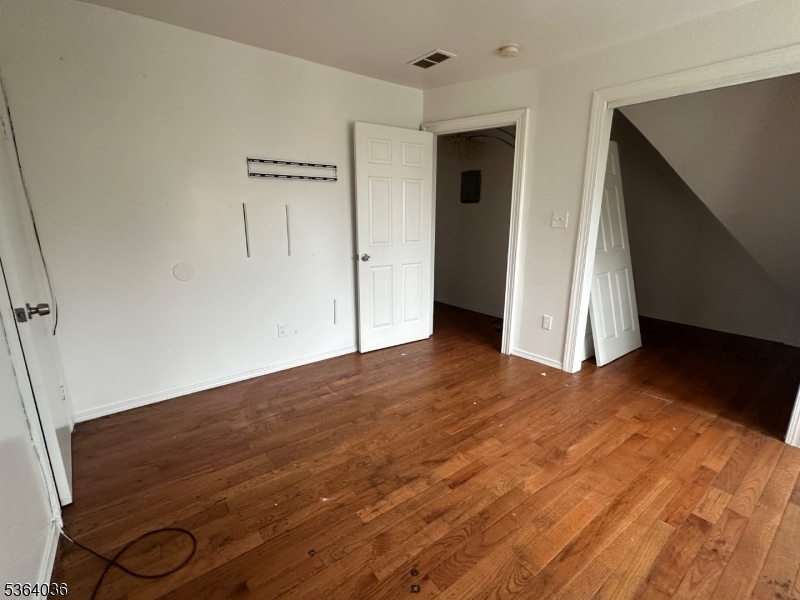 348 13th Avenue, Unit 3 Newark, NJ 07103 - Photo 13 of 14 a view of empty room with wooden floor