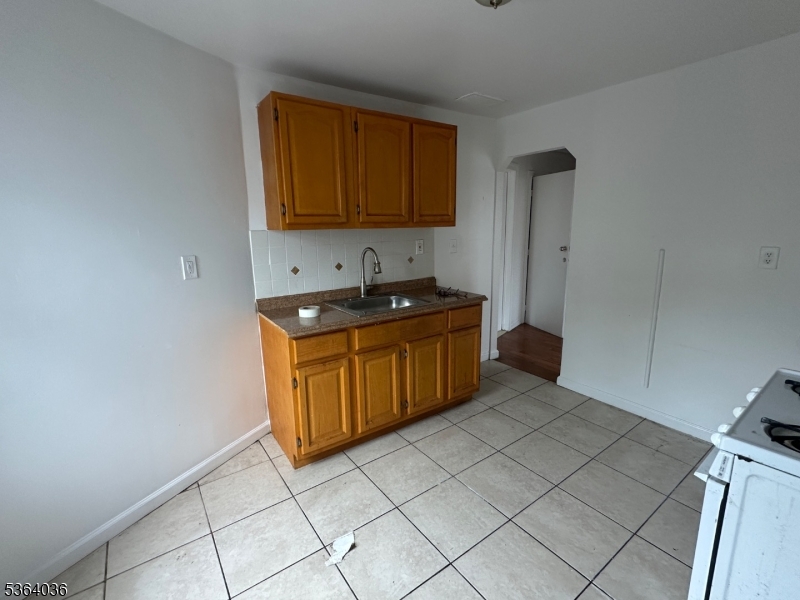 348 13th Avenue, Unit 3 Newark, NJ 07103 - Photo 4 of 14 a kitchen with a sink a stove and cabinets
