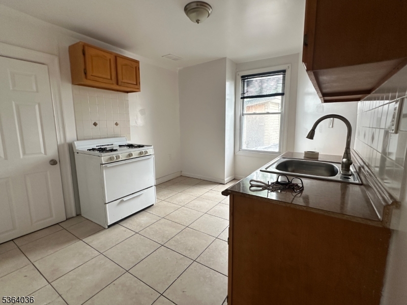 348 13th Avenue, Unit 3 Newark, NJ 07103 - Photo 6 of 14 a stove top oven sitting inside of a kitchen