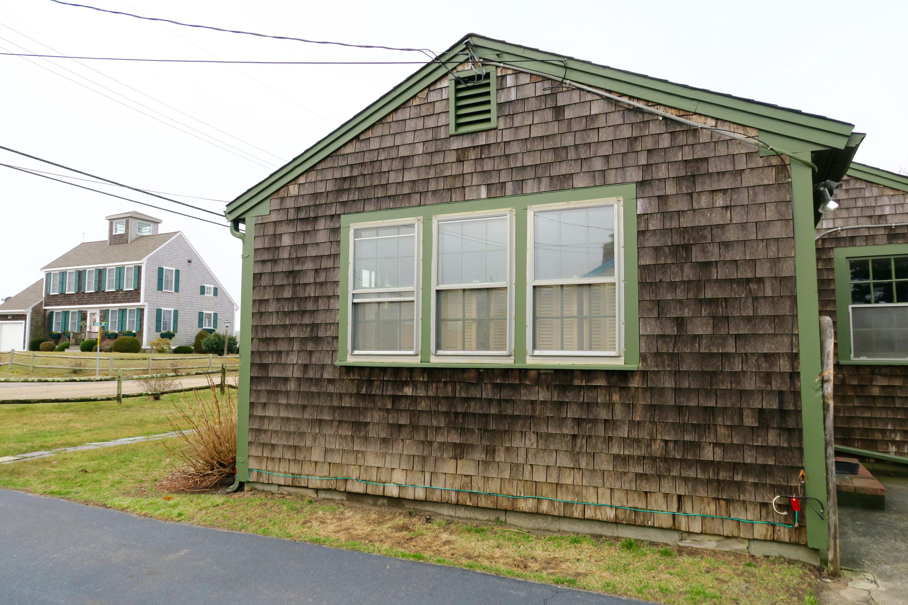 58 Surfside Road West Dennis, MA 02670 - Photo 24 of 31 a front view of a house with a yard
