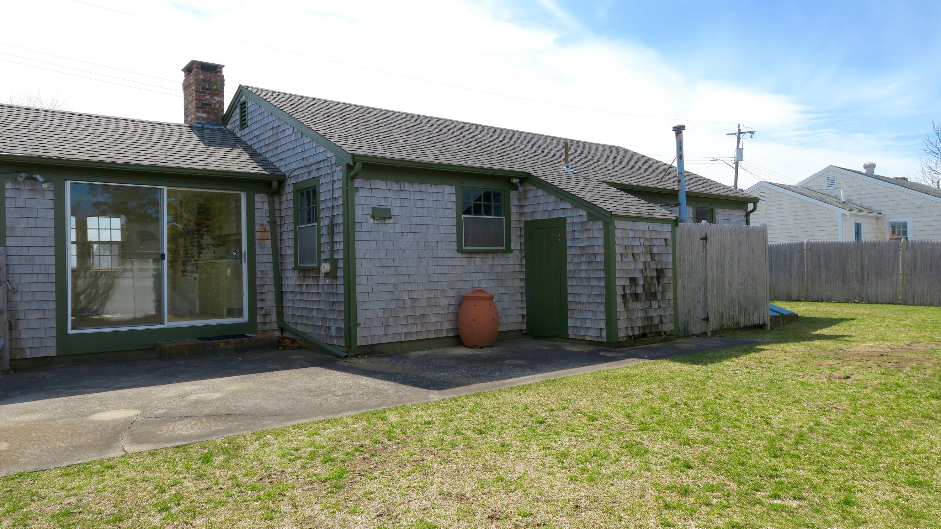 58 Surfside Road West Dennis, MA 02670 - Photo 25 of 31 a front view of a house with garden