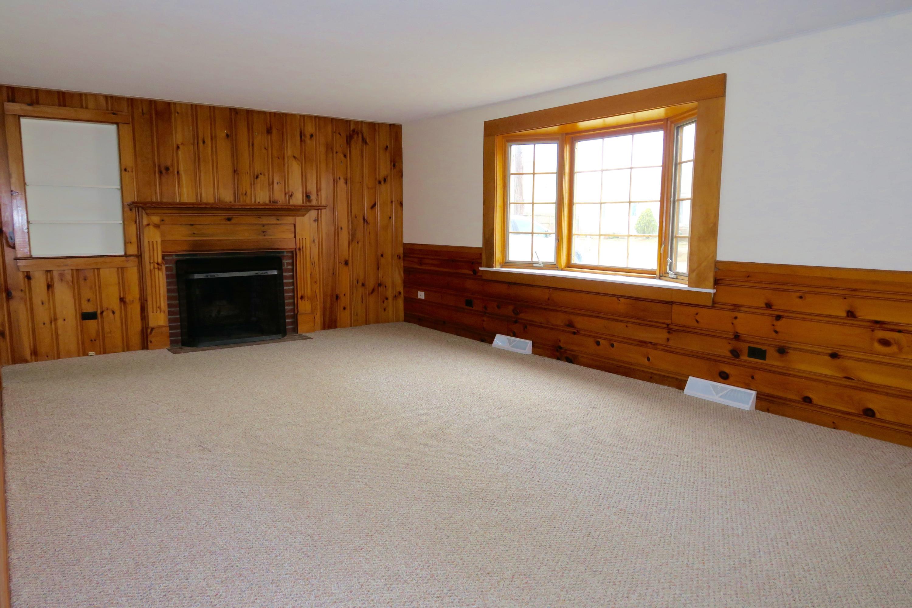 58 Surfside Road West Dennis, MA 02670 - Photo 9 of 31 an empty room with furniture and a fireplace