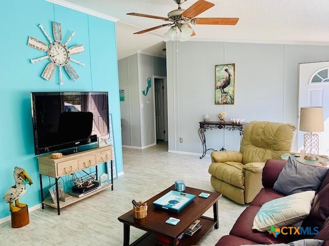 77 Blue Street Port O'Connor, TX 77982 - Photo 12 of 27 a living room with furniture and a flat screen tv