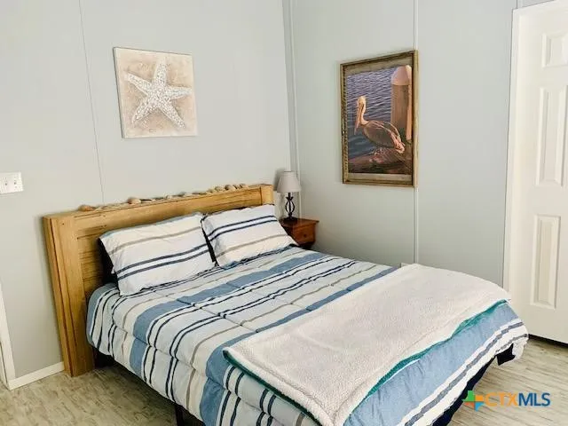 a bedroom with a bed and wall painting
