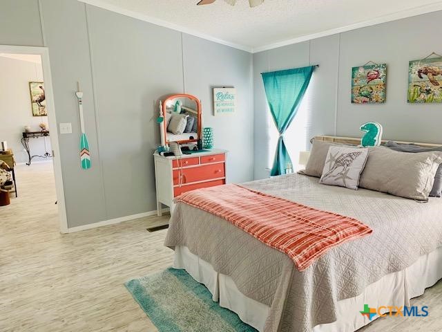 77 Blue Street Port O'Connor, TX 77982 - Photo 17 of 27 a bedroom with a bed and a dresser
