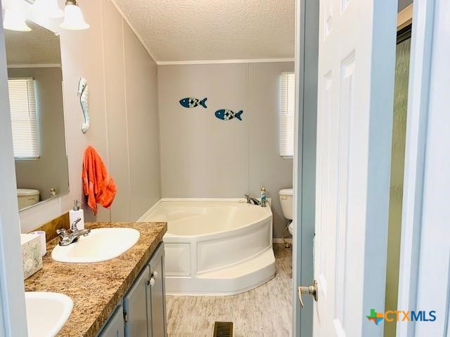 77 Blue Street Port O'Connor, TX 77982 - Photo 18 of 27 a bathroom with a granite countertop sink and a mirror