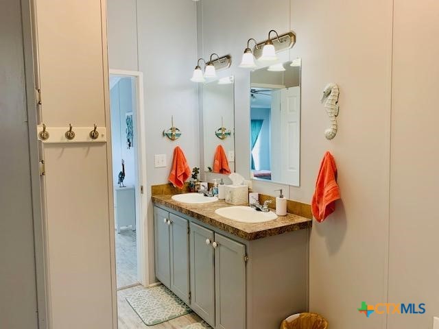 77 Blue Street Port O'Connor, TX 77982 - Photo 19 of 27 a bathroom with a sink vanity and a mirror