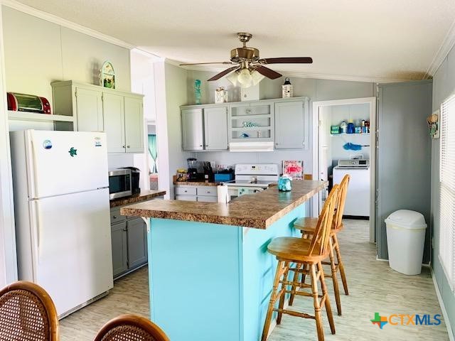 77 Blue Street Port O'Connor, TX 77982 - Photo 22 of 27 a kitchen with stainless steel appliances granite countertop a dining table chairs a refrigerator and a sink