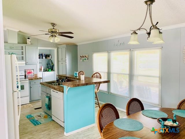 77 Blue Street Port O'Connor, TX 77982 - Photo 23 of 27 a kitchen with kitchen island stainless steel appliances a sink stove and a window