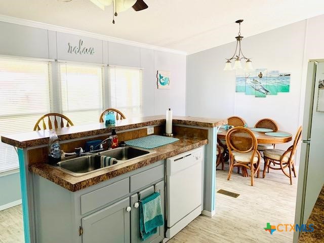 77 Blue Street Port O'Connor, TX 77982 - Photo 24 of 27 a kitchen that has a stove and a table in it
