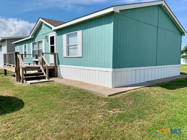 77 Blue Street Port O'Connor, TX 77982 - Photo 3 of 27 a view of backyard with deck and seating area