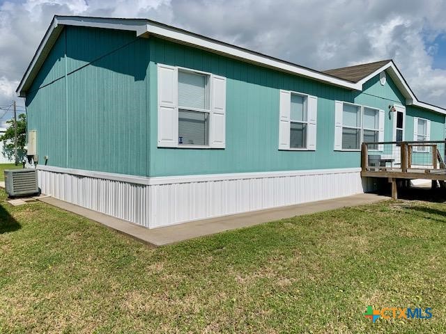 77 Blue Street Port O'Connor, TX 77982 - Photo 4 of 27 a house with a trees in the background