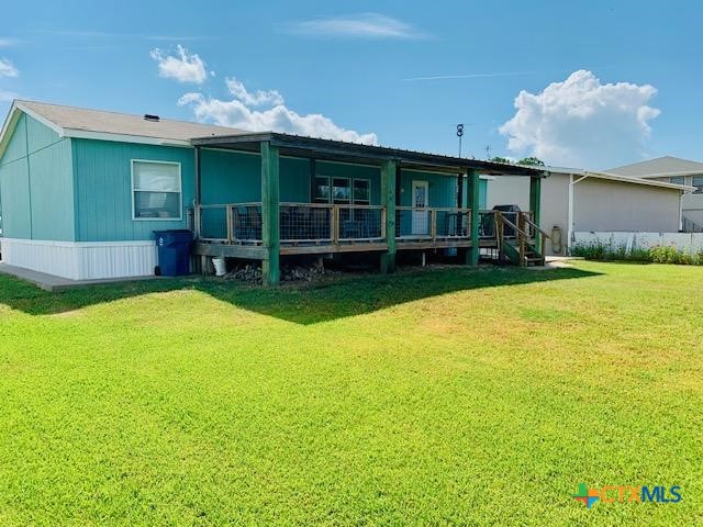 77 Blue Street Port O'Connor, TX 77982 - Photo 7 of 27 a view of a house with a backyard and a patio