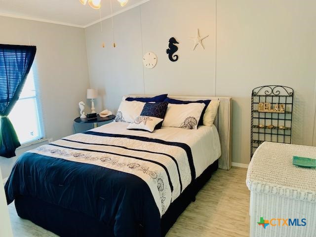 77 Blue Street Port O'Connor, TX 77982 - Photo 8 of 27 a bedroom with bed and a window