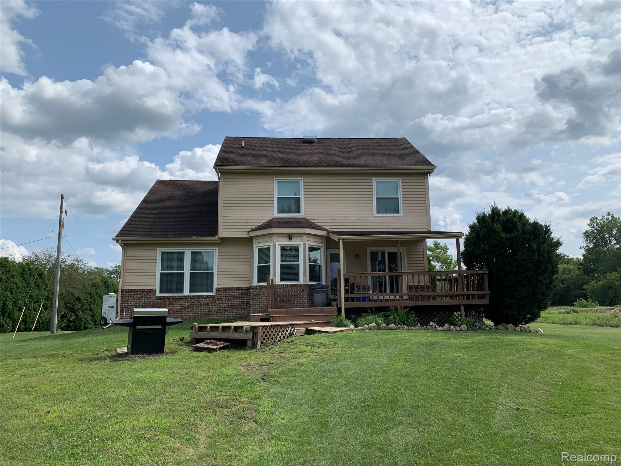 57260 12 Mile Road New Hudson, MI 48165 - Photo 2 of 22 back of house.jpg