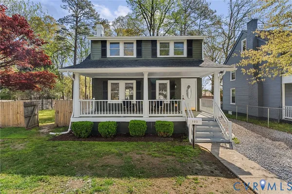 a view of a house with a yard and a garden