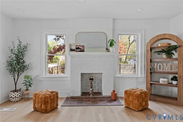 a living room with furniture a potted plant and a fireplace