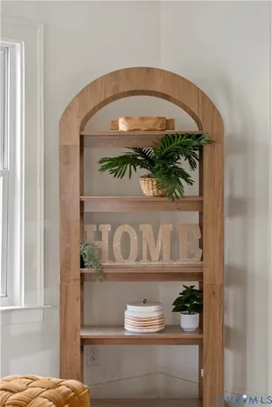 a dining room with furniture a chandelier and wooden floor