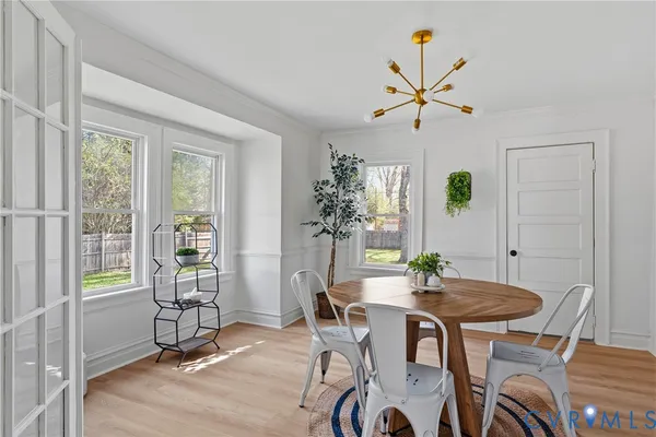 a view of a dining room with furniture and a potted plant
