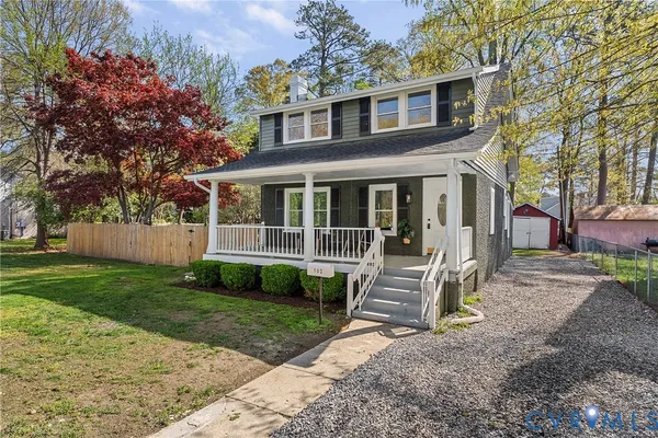 a front view of a house with a garden and porch