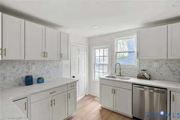 a kitchen with appliances cabinets and a sink