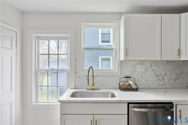 a close view of sink and mirror with window