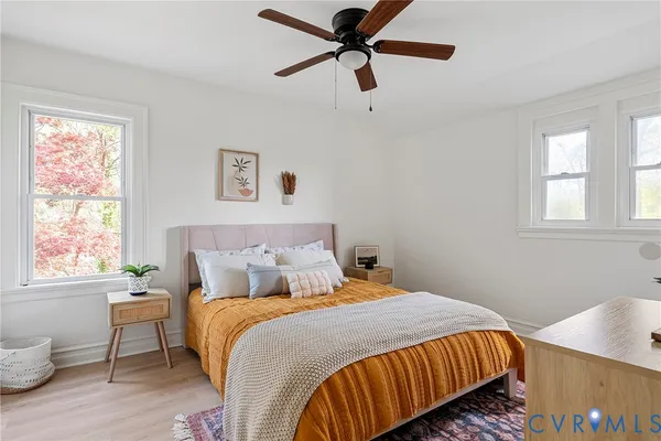 a bedroom with a bed and painting on the wall