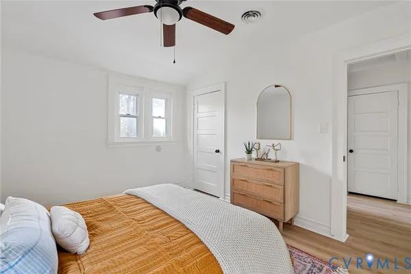 a bedroom with a bed and a dresser