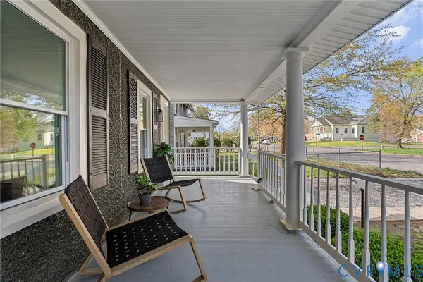 a view of a porch with chairs and couches