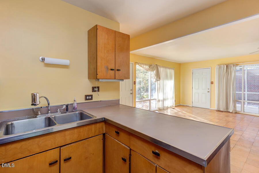 806 Kings Mill Road Chapel Hill, NC 27517 - Photo 14 of 45 a kitchen with a sink cabinets and window