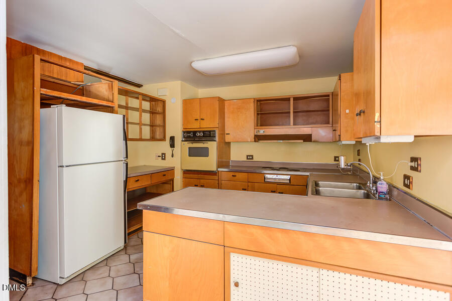 806 Kings Mill Road Chapel Hill, NC 27517 - Photo 15 of 45 a kitchen with stainless steel appliances a refrigerator sink and cabinets