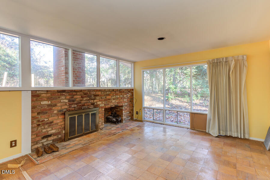 806 Kings Mill Road Chapel Hill, NC 27517 - Photo 8 of 45 an empty room with furniture and a fireplace