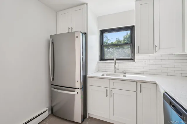 a white refrigerator freezer sitting inside of a kitchen