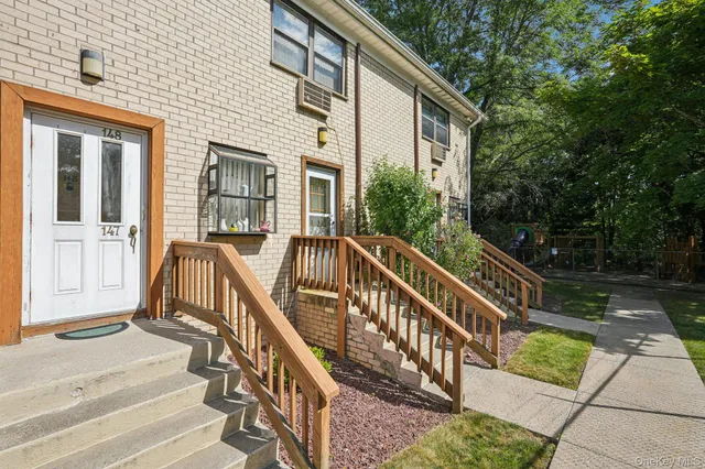 a view of a house with backyard and deck
