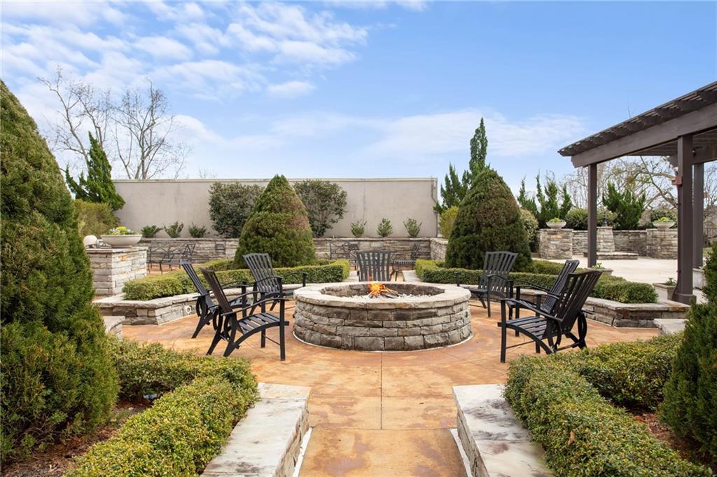 2255 Peachtree Road Northeast, Unit 326 Atlanta, GA 30309 - Photo 23 of 37 a view of a patio with couches and table and chairs and potted plants