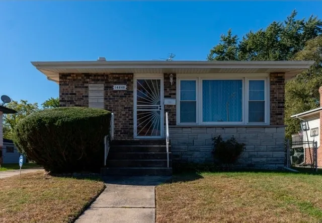a front view of a house with a garden