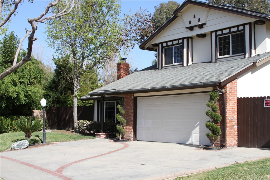 23642 Cavanaugh Road Lake Forest, CA 92630 - Photo 2 of 14 a view of a white house with a potted plant and a large windows